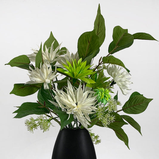 Verdant foliage contrasts with spider chrysanthemums to deliver a dramatic focus piece with bright green and ivory dahlias in a stylish black vase.  SIZE:  W50xH70cm  *Found Object – may not mean a new vessel/vase, but one which has been ‘found’ during our searches.  Please note: Sale price is for pictured item (Floor model) - ONE ONLY.