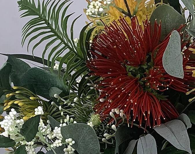 Beautiful artificial flower bouquet includes Pohutukawa, spider chrysanthemums, eucalyptus leaves, bird of paradise, and leucospermum. The stunning oranges and reds give this bouquet its exotic look, and very much a Kiwi feel. Atelier Blooms Auckland