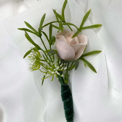 A beautiful hand-crafted paper (faux) Blush rose boutonnieres, mixed with artificial foliage, are made to order to match your wedding theme colour and are perfect for the groom, groomsmen, and fathers for your special day. Atelier Blooms NZ