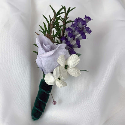 A beautiful hand-crafted paper (faux) small mauve rose boutonnieres, with a green satin stem, mixed with artificial flowers and foliage, are made to order to match your wedding theme colour and are perfect for the groom, the groomsmen, and fathers for your special occasion. Atelier Blooms
