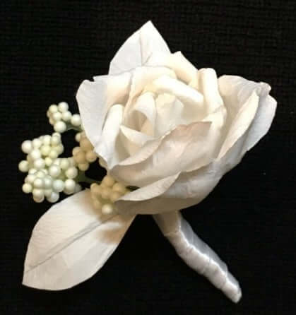 A beautiful hand-crafted paper (faux) all white rose boutonnieres, mixed with artificial foliage, are made to order to match your wedding theme colour and are perfect for the groom, groomsmen, and fathers for your special day. Atelier Blooms NZ
