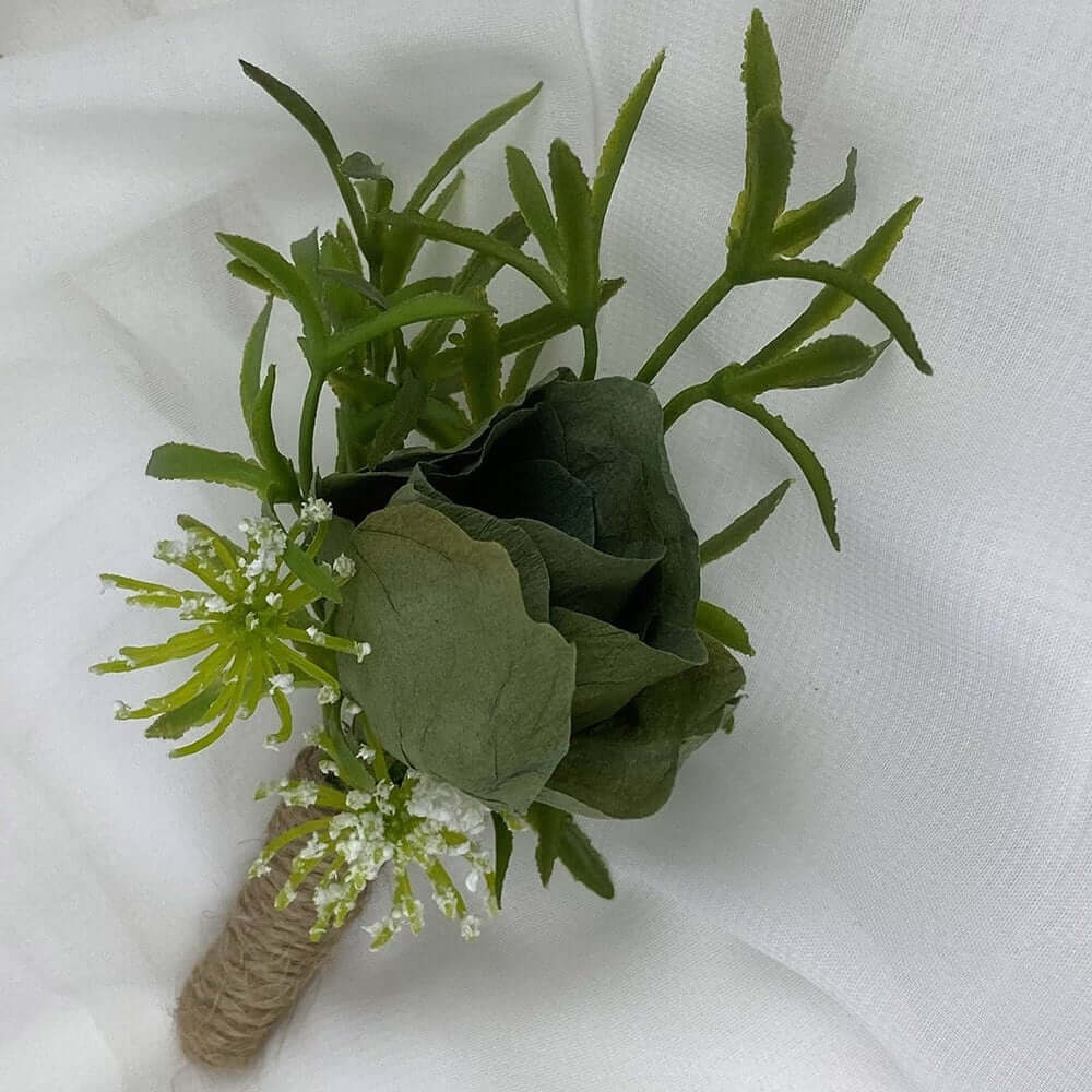A beautiful hand-crafted paper (faux) single green rose boutonnieres, mixed with artificial foliage, are made to order to match your wedding theme colour and are perfect for the groom, groomsmen, and fathers for your special day. Atelier Blooms NZ