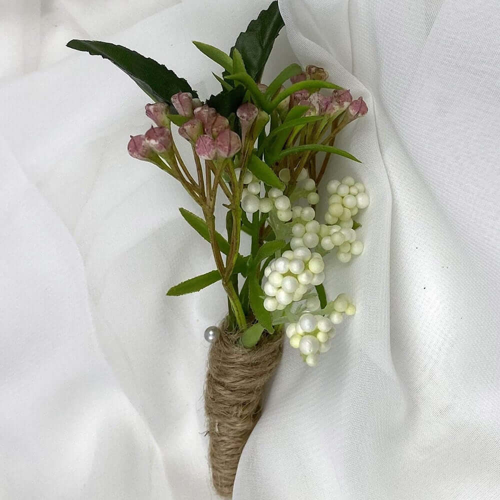 A beautiful artificial foliage boutonnieres, with a twine satin stem, mixed with artificial flowers and foliage, are made to order to match your wedding theme colour and are perfect for the groom, the groomsmen, and fathers for your special day. Atelier 