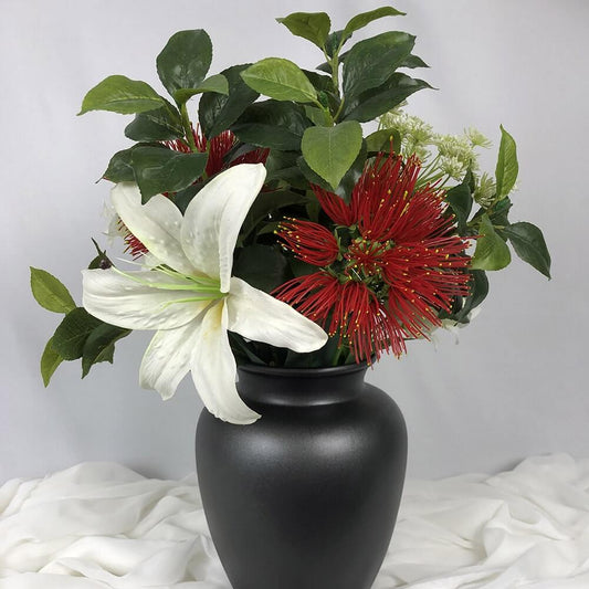 Gorgeous Pohutukowa arrangement mixed with a white Lilly and artificial greenery in a lovely black jug.  The taste of summer!  Size: H45 x W35cm  This piece is available with other flowers or custom shades, please contact us for a custom/bespoke quote.  *Found Object – may not mean a new vessel/vase, but one which has been ‘found’ during our searches.