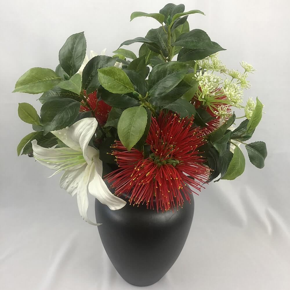 Gorgeous Pohutukowa arrangement mixed with a white Lilly and artificial greenery in a lovely black jug.  The taste of summer!  Size: H45 x W35cm  This piece is available with other flowers or custom shades, please contact us for a custom/bespoke quote.  *Found Object – may not mean a new vessel/vase, but one which has been ‘found’ during our searches.