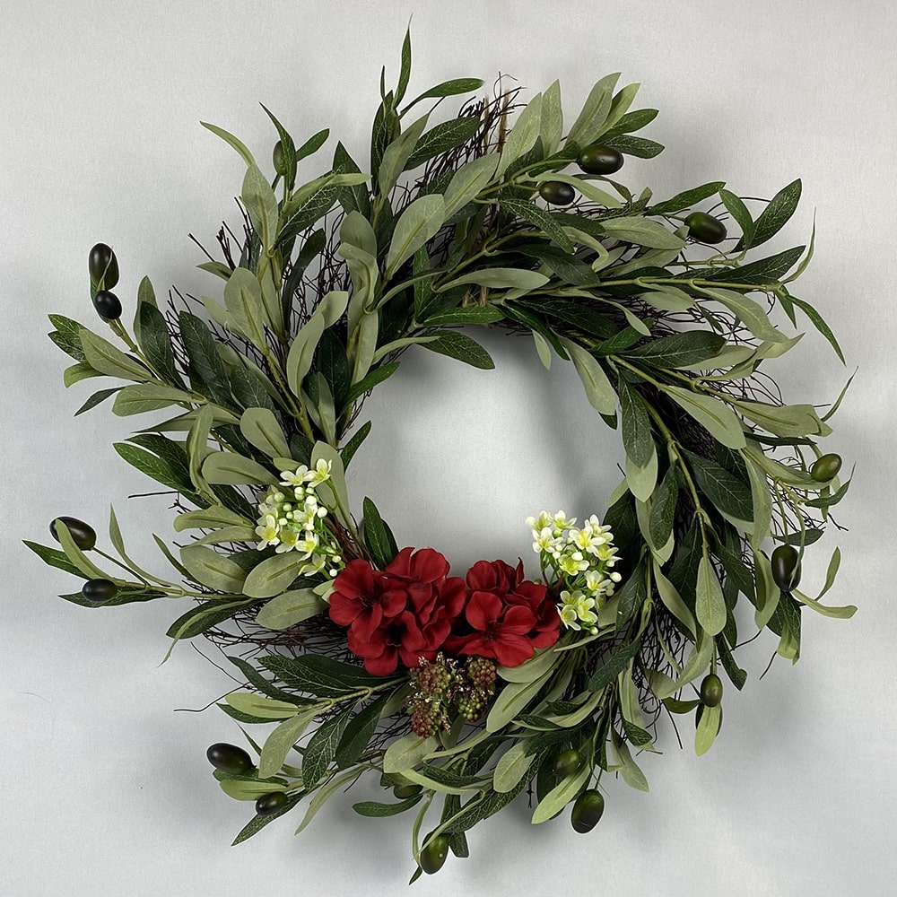 Our stunning Olive Wreath has ripe black olives and wax flowers with deep red geraniums, simultaneously simple, rustic and stunning. The supporting wreath is made of dried birch twigs.  Size: 45cm outer/20cm inner diameter