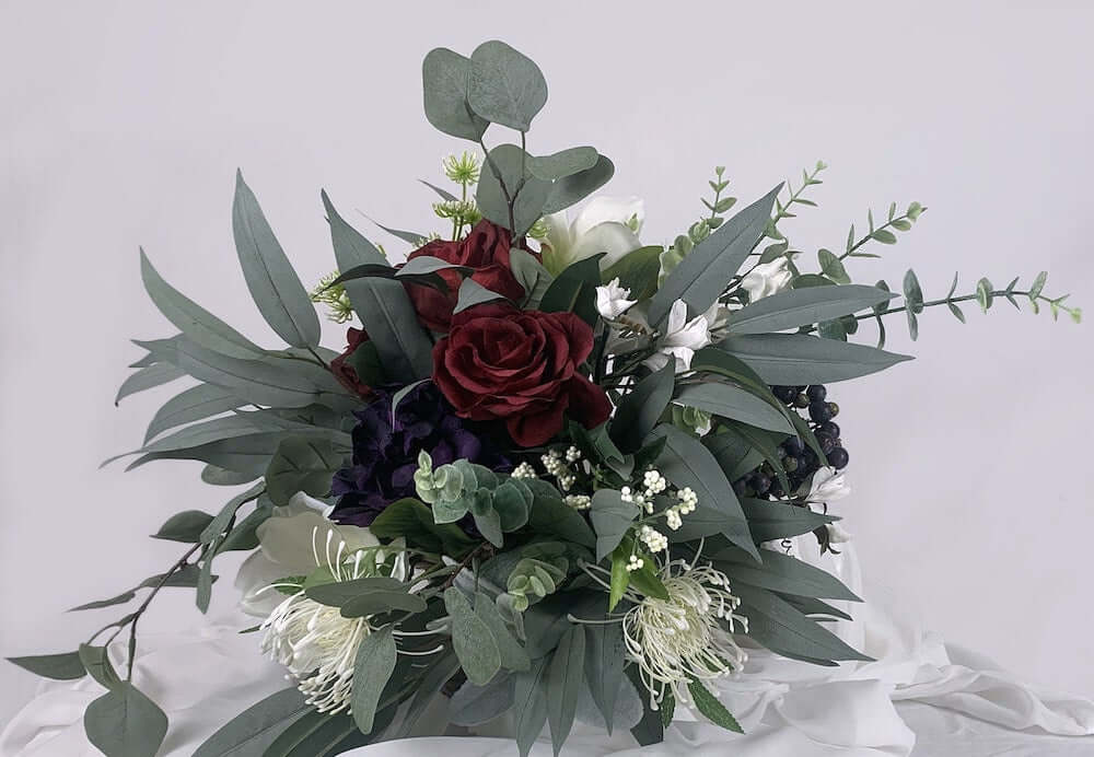 Stunning deep gem-coloured, hand-crafted paper flowers including roses, peonies, and chrysanthemums mixed with artificial florals including magnolia and spider chrysanthemums, artificial wedding flowers nz, silk flowers, Auckland