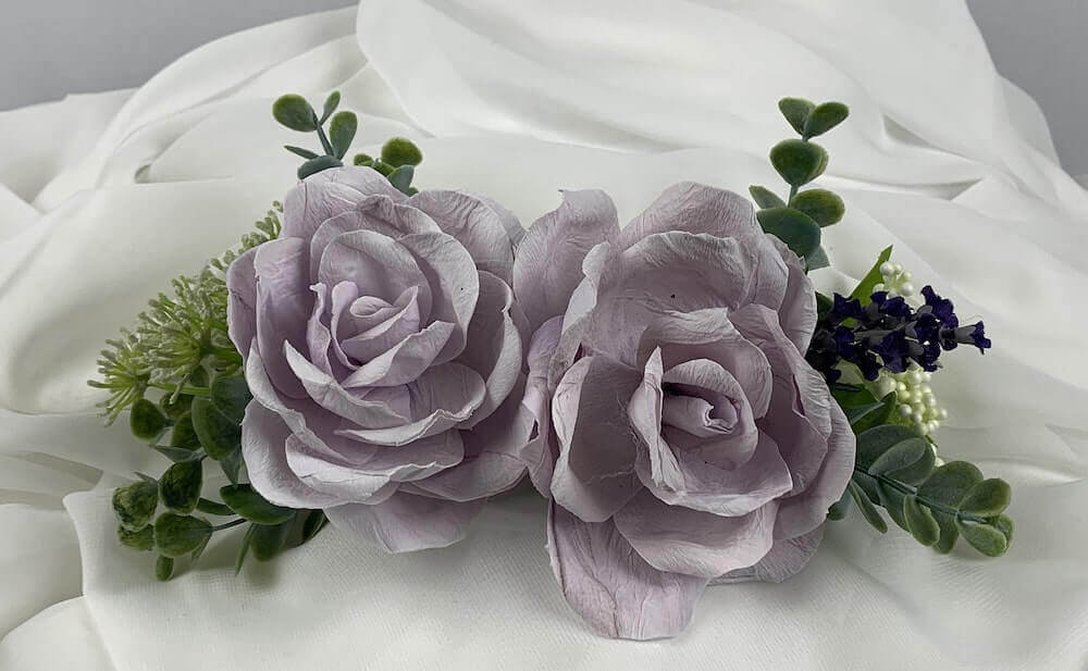 Lovely bridal comb, colour matched to your wedding theme, with two beautiful hand-crafted roses, paired with artificial flowers and eucalyptus.  This accessory can be colour matched to your theme and can be worn by both bride and her bridesmaids. Atelier Blooms Auckland