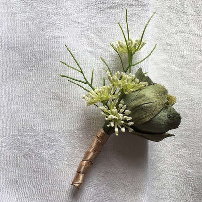 A beautiful hand-crafted paper (faux) single green bonnybell rosebud boutonnieres, mixed with artificial foliage, are made to order to match your wedding theme colour and are perfect for the groom, groomsmen, and fathers for your special day. Atelier Blo
