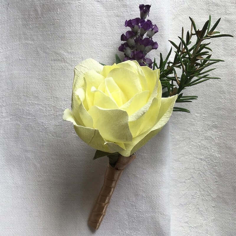 A beautiful hand-crafted paper (faux) single yellow rosebud boutonnieres, mixed with artificial foliage, are made to order to match your wedding theme colour and are perfect for the groom, groomsmen, and fathers for your special day. Atelier Blooms NZ