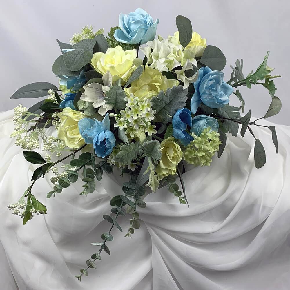 Gorgeous hand-crafted paper flowers of yellow and blue paper roses mixed with artificial flowers including snowball hydrangea, Queen Anne's lace, eucalyptus, and succulents. This beautiful bouquet will make any bride feel special. Size Bouquet: 40cm dia