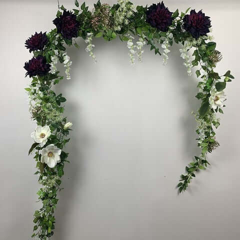 This beautiful garland is a mix of rich, deep aubergine madrid dahlia's, wisteria, spider chrysanthemums and Queen Anne lace. Can be hung anywhere or straightened out to place on your wedding table or fireplace mantle for a backdrop for your wedding photo