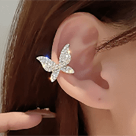 A woman showcasing a non-piercing butterfly ear cuff-Beautiful sparkling butterfly ear cuff without piercing. Ear cuffs are versatile accessories that can be worn in various ways. They are usually very comfortable to wear all day long and they don't require any piercing. So, if your ears are not pierced, ear cuffs are great fit for you as ear jewellery. Size: H1.7cm x W1.9cm Weight: 5.2gm